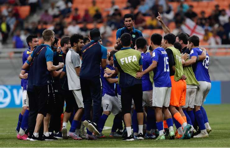 Uzbekistan players and officials celebrate after the FIFA U-17 World Cup round of sixteen match between England and Uzbekistan at the Jakarta International Stadium, Indonesia, 22 November 2023. Uzbekistan won the match 2-1. EPA/ADI WEDA